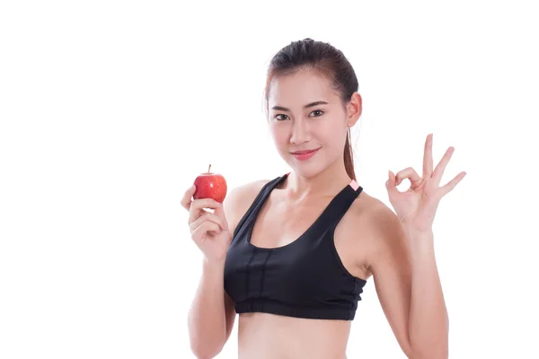 Fitness woman holding apple and showing ok sign. healty concept — Stock Photo, Image