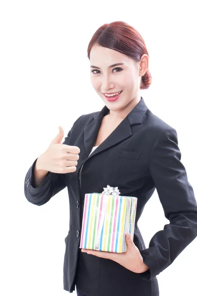 Beautiful businesswoman with gift box and showing thumb up. — Stock Photo, Image