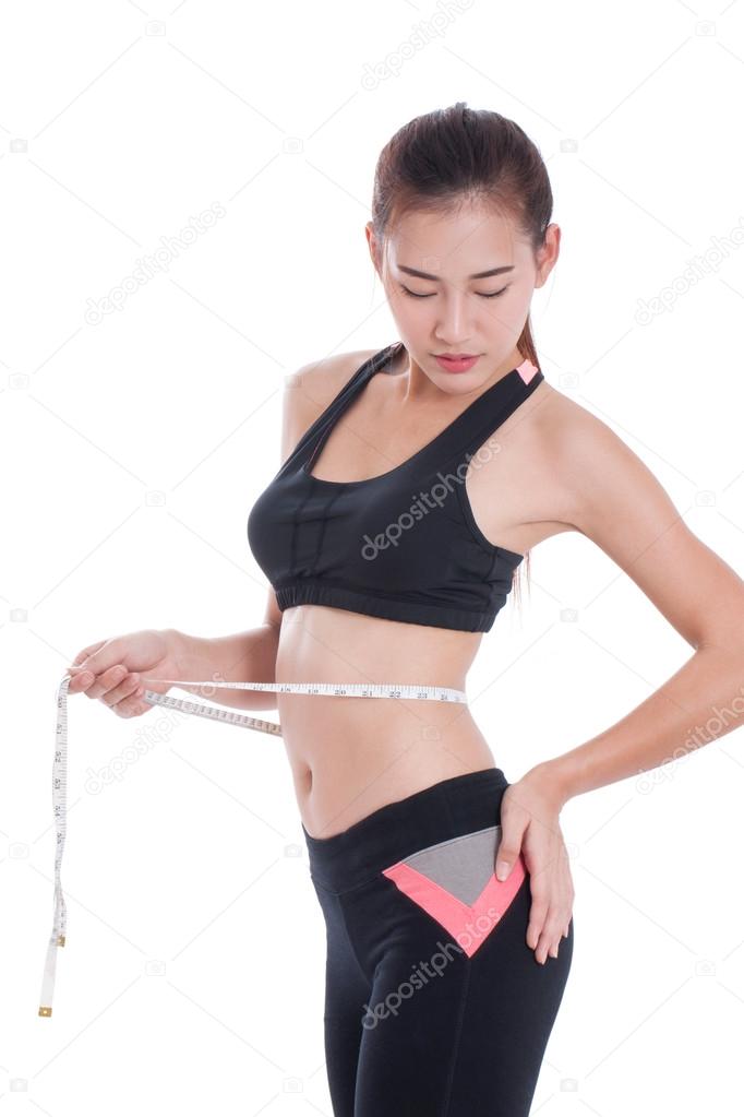 Fitness woman taking measurements of her body. healthy concept
