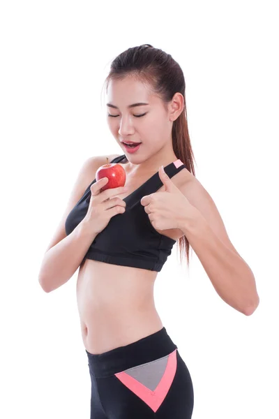 Fitness woman holding apple and showing thumb up. — Stock Photo, Image