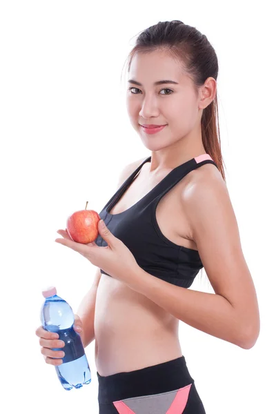 Fitness young woman holding a bottle of water and an apple — Stock Photo, Image