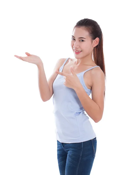 Beautiful young woman pointing and showing open hand palm — Stock Photo, Image