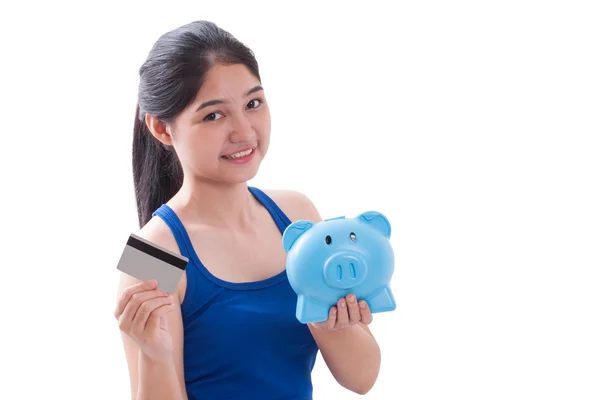 Young Woman holding piggy bank and card — Stock Photo, Image