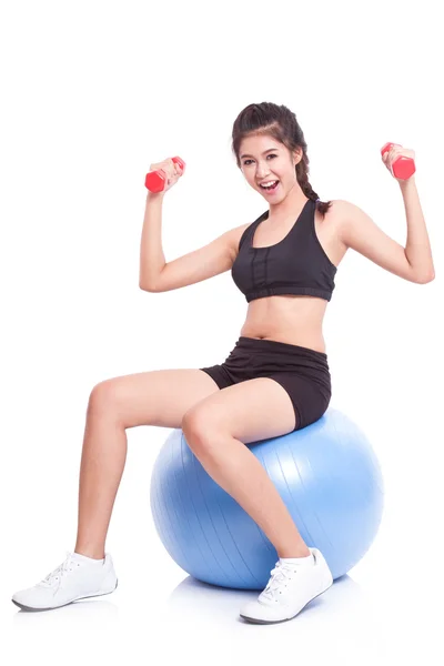 Woman training with exercise ball and weights — Stock Photo, Image