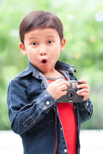 Asian boy with compact camera. — Stock Photo, Image