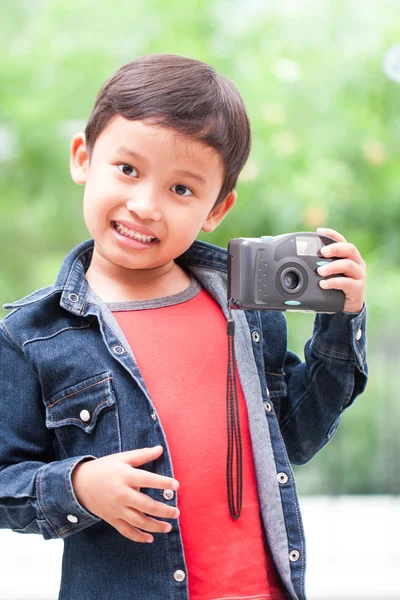 Asian boy with compact camera. — Stock Photo, Image