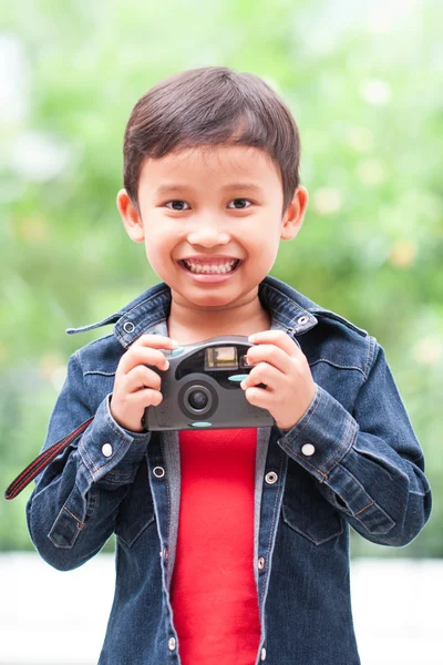 Asian boy with compact camera. — Stock Photo, Image