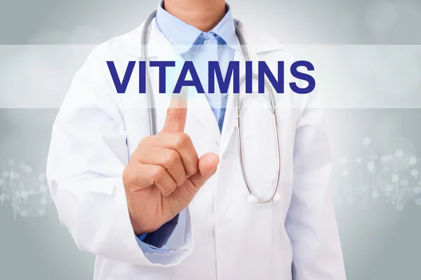 Doctor touching vitamins sign — Stock Photo, Image