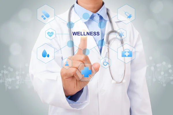 Doktor dotýká wellness znamení — Stock fotografie