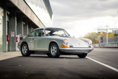 Brno, Czech Republic - October 24, 2025: Old luxury sports car Porsche 911 outdoors on a race track. Silver fast German car.