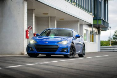 Brno, Czech Republic - October 24, 2025: Blue Subaru BRZ sports car parked outside on the street next to a building. Fast small Japanese car.