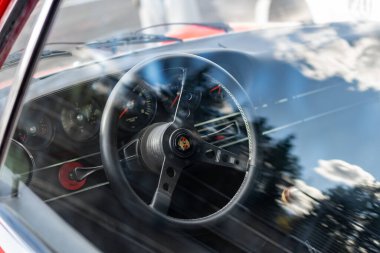 Brno, Czech Republic - October 10, 2025: Interior of an old Porsche 911 sports car. View of the steering wheel, car controls and dashboard.