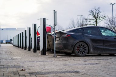 Brno, Çek Cumhuriyeti - 31 Aralık 2025: Tesla elektrikli arabaların şarj istasyonları sırası. Sokakta arabaları şarj ediyor..