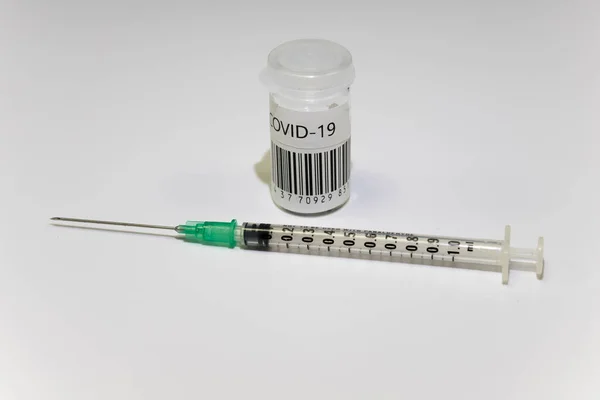 Corronavirus vaccination dose ready for immunisation. Hypodermic needle and covid-19 vaccine in a small glass vial