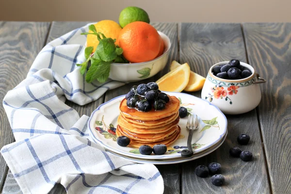 Pancakes with blueberries and honey on the table Royalty Free Stock Images