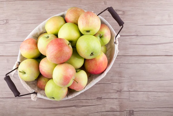 Fresh organic apples in basket on wooden table. Harvesting fruits background — Stock Photo, Image