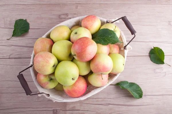 Fresh ripe apples in basket on wooden table. Organic fruits. Harvesting — Stock Photo, Image