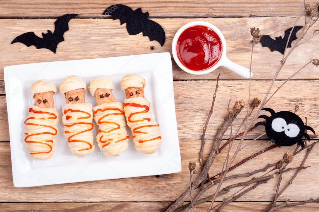 Funny sausage mummies with ketchup for Halloween
