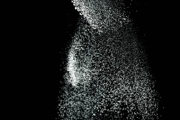 White powder explosion. White powder splash isolated on black background. Flour sifting on a dark background. Explosive powder white