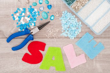 Crystals, pendants, charms, plier, glass hearts, box with beads,