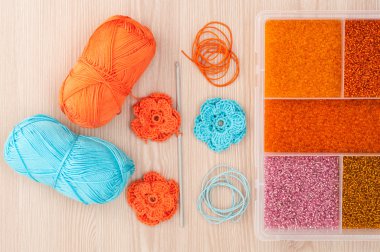 Handmade knitted crochet flowers and box with beads to create ha