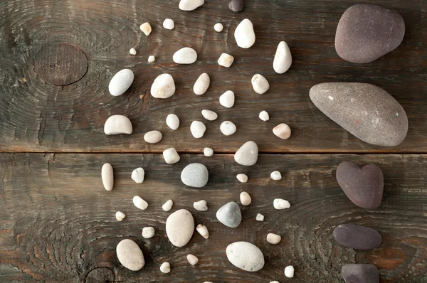 Sea stones on wooden background — Stock Photo, Image