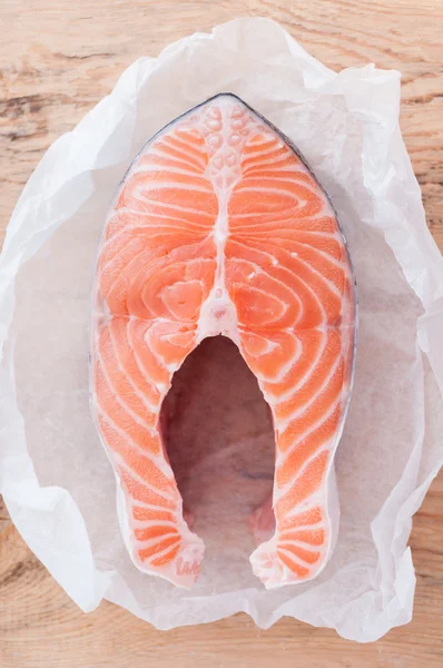 Salmon fish steak on wooden background — Stock Image Salmon fish steak on wooden background Royalty Free Stock Images