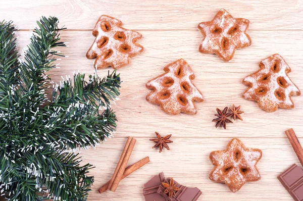 Gingerbread, chocolate, spices, artificial fir tree on a wooden — Stock Photo, Image