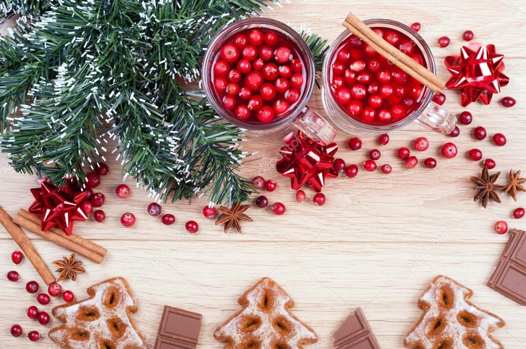 Christmas background. Tea with cranberries and cinnamon, cookies