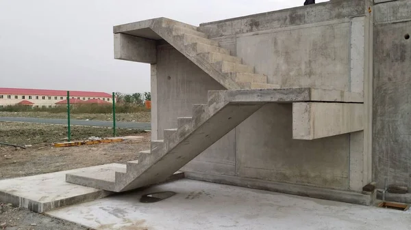Zdjęcie prostych, prefabrykowanych schodów betonowych z lądowaniami całkowicie zamontowanych na budynku w powłoce — Zdjęcie stockowe