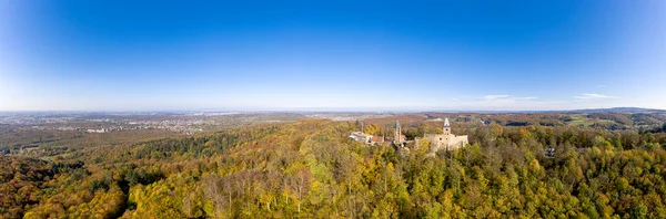 Drone photo of Frankenstein Castle near Darmstadt in Germany with a view over the Rhine-Main area during the day in autumn