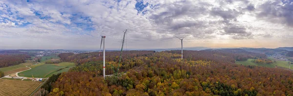 Drone image of a wind turbine under construction in a forest area in Germany in autumn