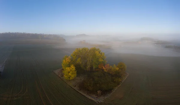 Drone image of morning ground fog over fields in the German province of North Hesse near the village of Rhoden in autumn