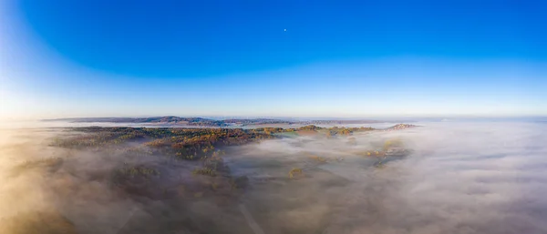 Drone image of morning ground fog over fields in the German province of North Hesse near the village of Rhoden in autumn