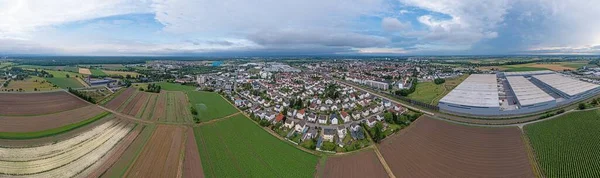 Drone panorama of German district town Gross-Gerau in south Hesse in the evening against cloudy sky