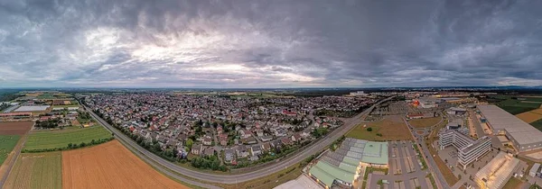 Drone panorama over German municipality Weiterstadt in southern Hesse during sunset