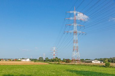 Yüksek voltajlı elektrik hattının görüntüsü. Yüksek elektrik direklerine sahip uyarı renkleriyle birlikte.