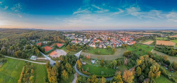 Drone panorama over German southern Hessian settlement Diedenbergen near Wiesbaden in evening light in summer