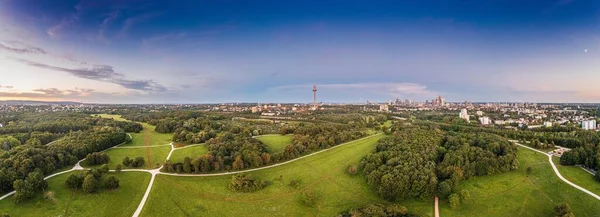 Drone panorama over Frankfurt skyline in evening light taken from Niddapark in summer