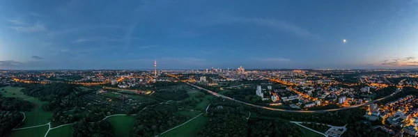 Drone panorama over Frankfurt skyline in evening light taken from Niddapark in summer