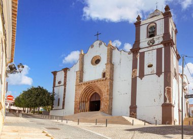 Silves 'deki tarihi katedral. Eski kasaba Algarve Portugal. Gotik kapısı ve mavi gökyüzünün altındaki çan kulesi..