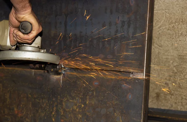 worker working with a metal saw