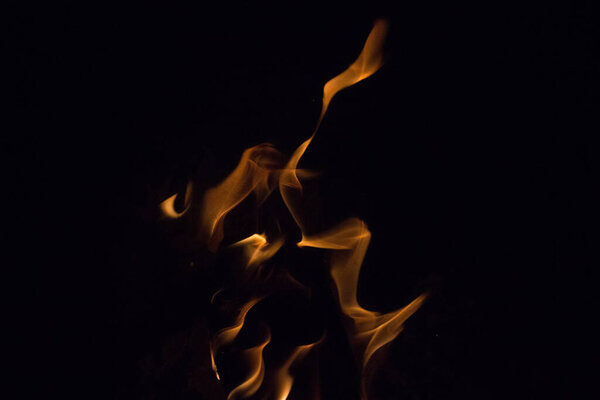 Bright fire on a black background at night