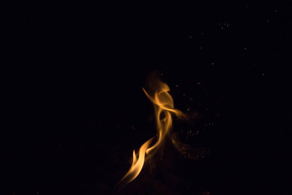 Sparks of fire on a black background at night