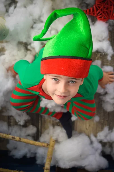 Chico vestido de elfo en navidad, ayudante de Santa Claus