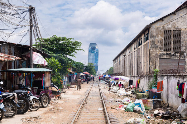 Phnom Penh, Phnom Penh / Cambodia - October 4th 2016: Image of rail train crossing shanty town in Phnom Penh.