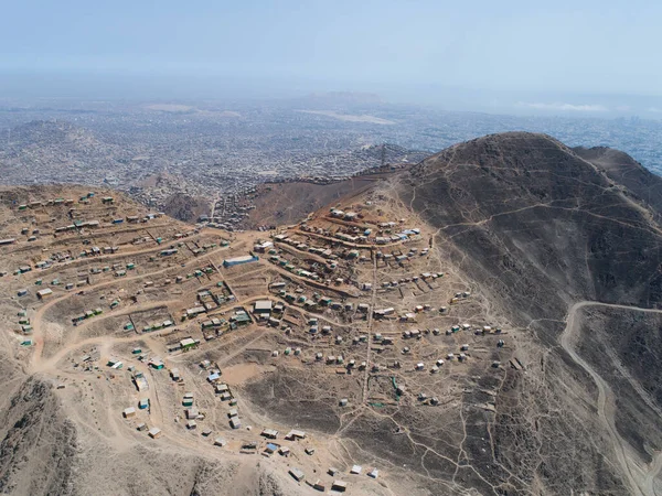 Aerial image of Lima Peru, shanty town in the hills. Image of Andes hills invaded. Small town, poverty.