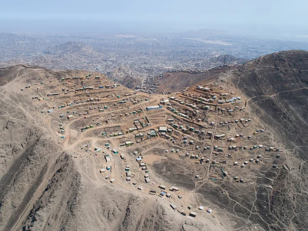 Image of a shanty town in the Andes coast hill in Lima Peru. Poverty living in hard conditions. Invasion of public lands for living.