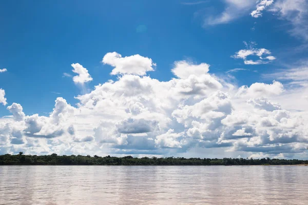 Image of river in Peruvian jungle. Amazon forest during day with clouds. Open nature traveling in the river.