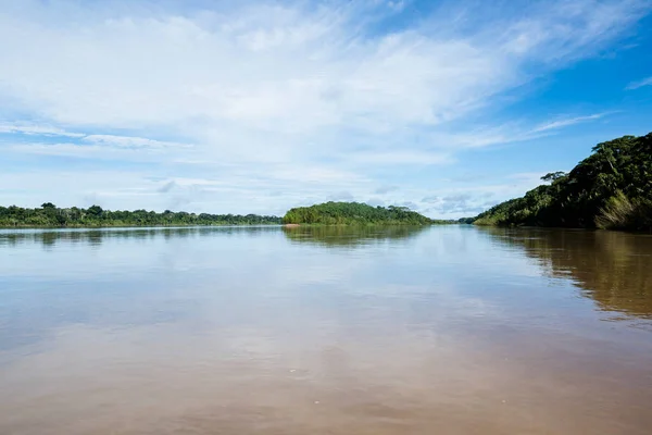 Image of river in Peruvian jungle. Amazon forest during day with clouds. Open nature traveling in the river.